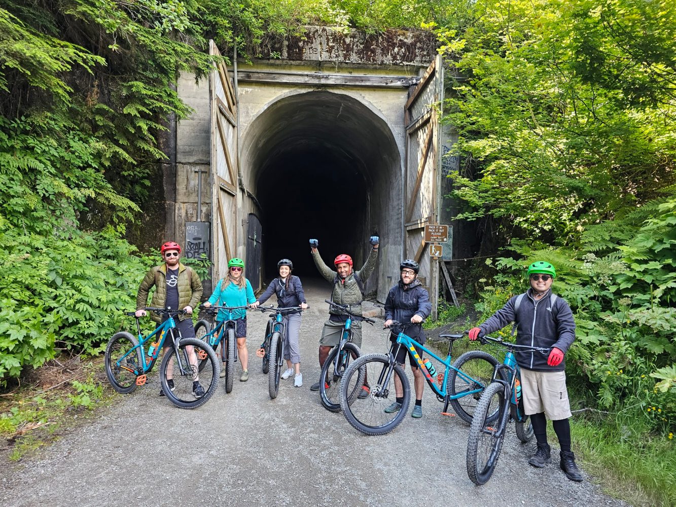 a group of bike riders in front of the Snoqualmie Tunnel