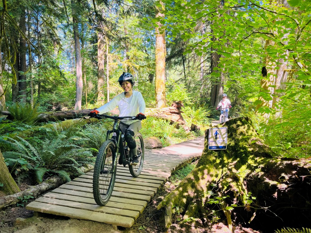 a man riding a bike down a dirt road