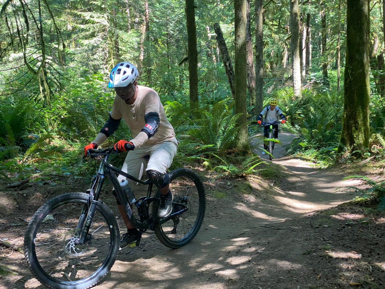 a man riding a bike down a dirt road